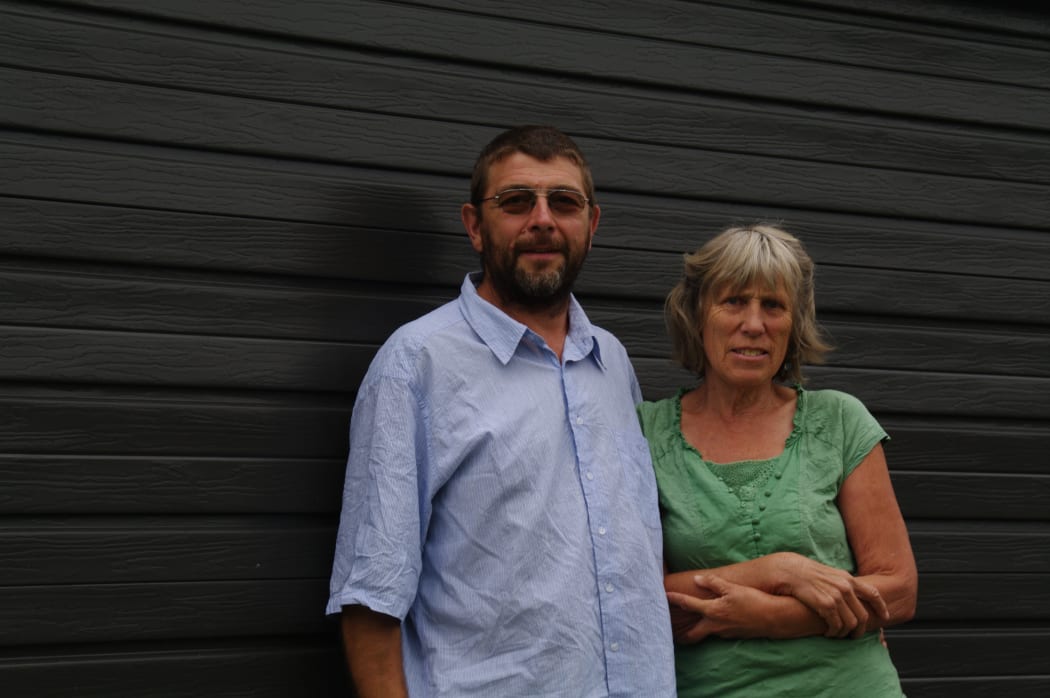 Janice Lee and Edgar Rochwalksi in front of their garage.