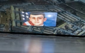 This photo illustration created on April 13, 2023, shows the suspect, national guardsman Jack Teixeira, reflected in an image of the Pentagon in Washington, DC. - FBI agents on Thursday arrested a young national guardsman suspected of being behind a major leak of sensitive US government secrets -- including about the Ukraine war. US Attorney General Merrick Garland announced the arrest made "in connection with an investigation into alleged unauthorized removal, retention and transmission of classified national defense information." (Photo by Stefani REYNOLDS / AFP)