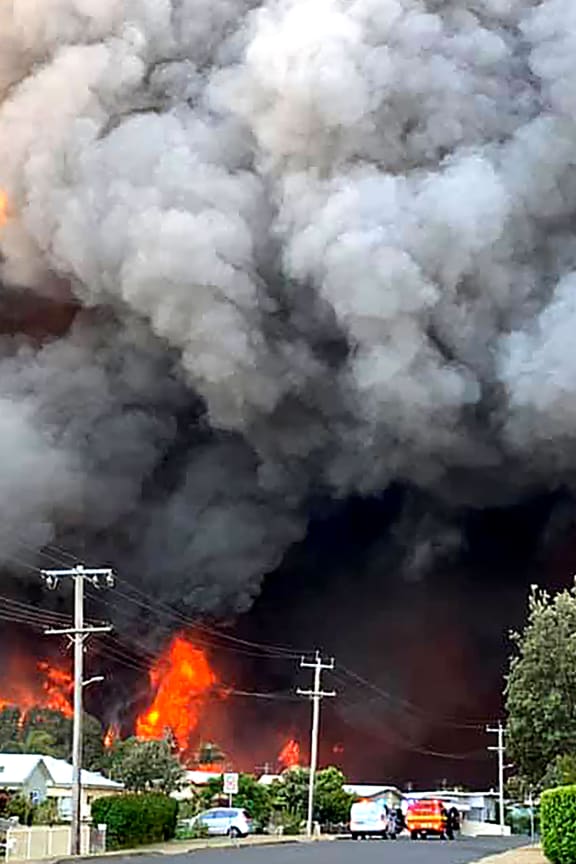 Flames from an out of control bushfire seen from a nearby residential area in Harrington, some 335 kilometers northeast of Sydney.