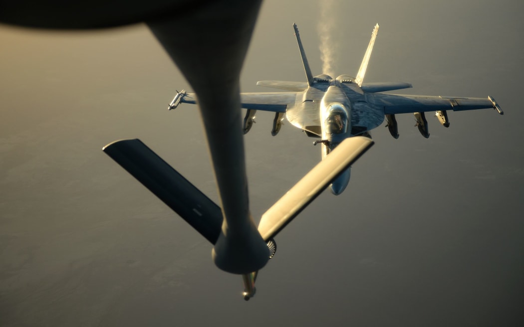 A US Navy F-18E Super Hornet receives fuel over northern Iraq after conducting air strikes in Syria.