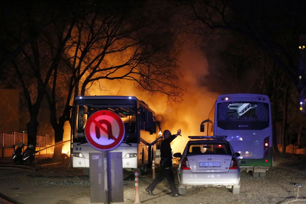 Firefighters try to extinguish flames after the attack.