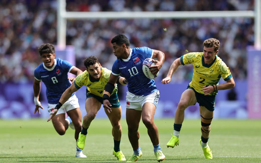 Samoa break through the Australian defence during the first day of the 2024 Paris Olympic Games at the Stade de France in Paris on July 24, 2024. Photo credit: Mike Lee - KLC fotos for World Rugby