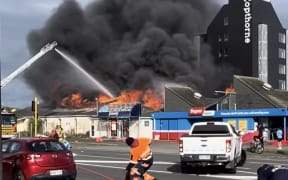 Photos posted online showed flames and a large cloud of smoke rising from a building on Palmerston North's Ferguson Street, on Thursday 30 October, 2025.