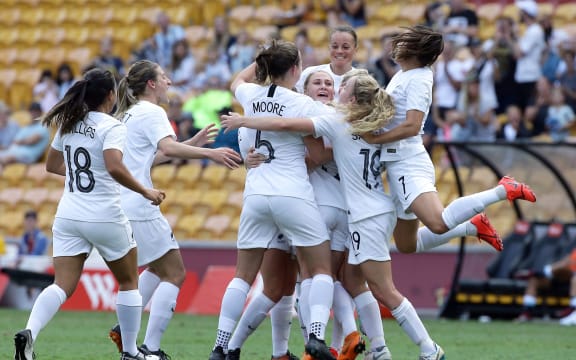 New Zealand's CJ Bott, center, celebrates with the team after scoring a goal.