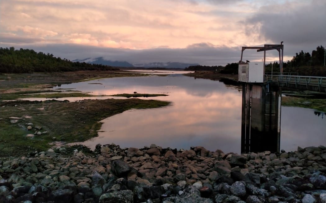 A depleted Kapitia Reservoir on June 27, revealing its weed covered bed.