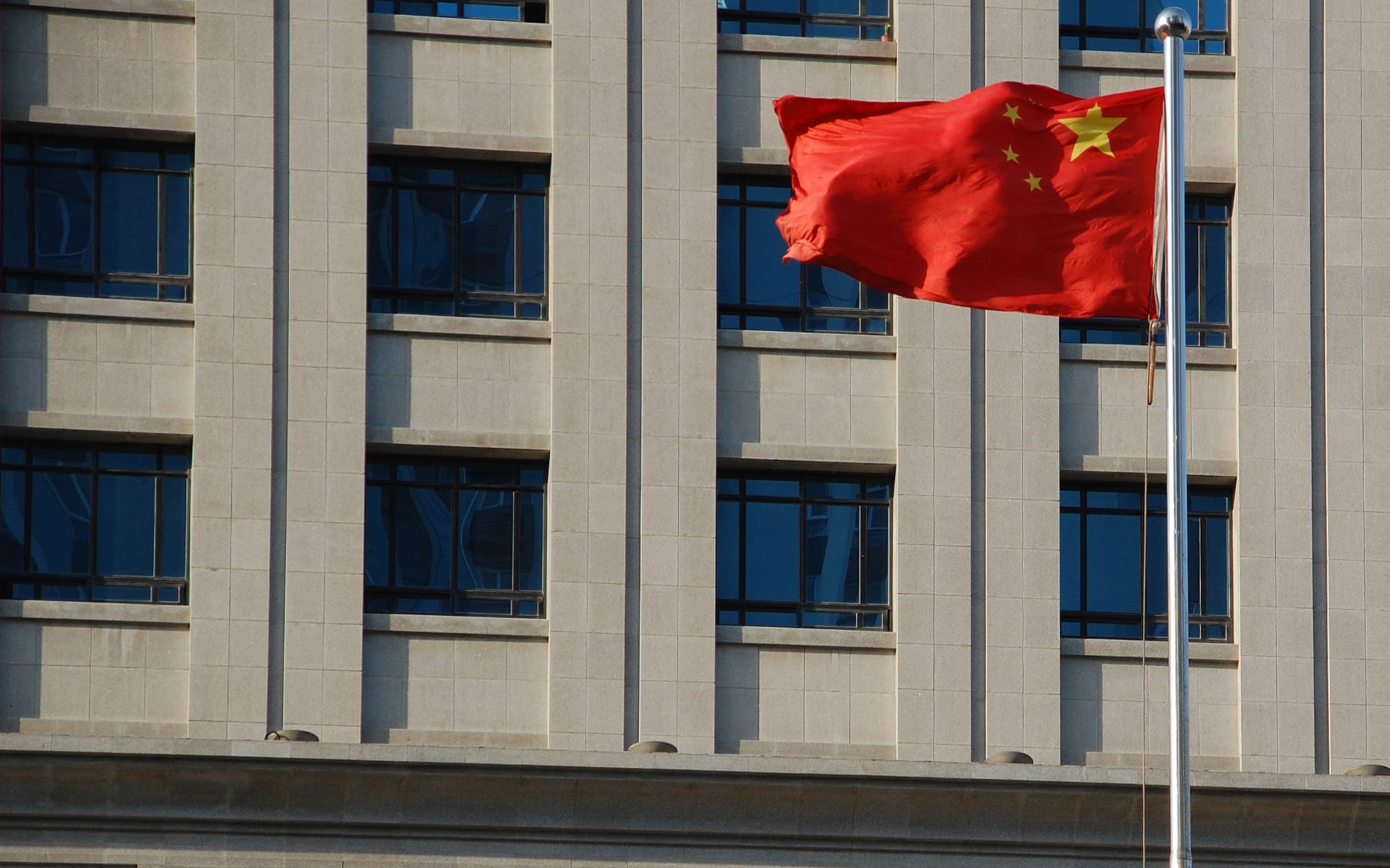 A flag flies in front of a court house in Shangdong Province, China.