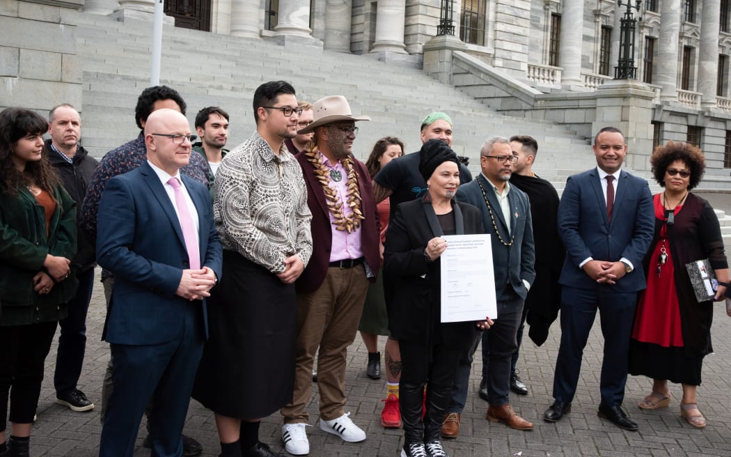 MPs, supporters and the co-authors of the petition gather for photos.
