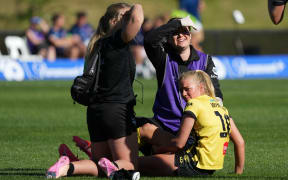 Phoenix Alyssa Whinham sits injured on the field.