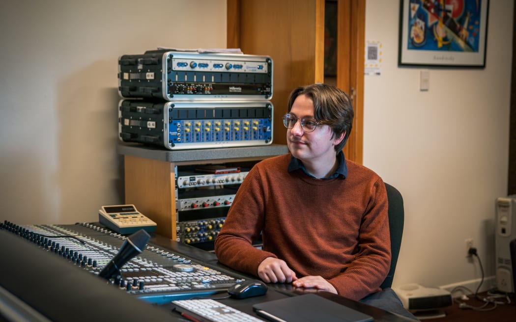 Composer William Philipson sits in his studio