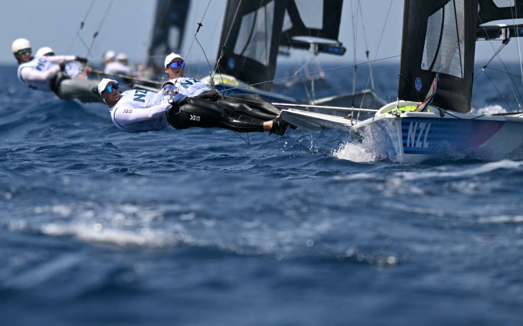 New Zealand's duo Jo Aleh and Molly Meech compete in Race 8 of the women’s 49erFX skiff event during the Paris 2024 Olympic Games sailing competition at the Roucas-Blanc Marina in Marseille on July 30, 2024. (Photo by NICOLAS TUCAT / AFP)