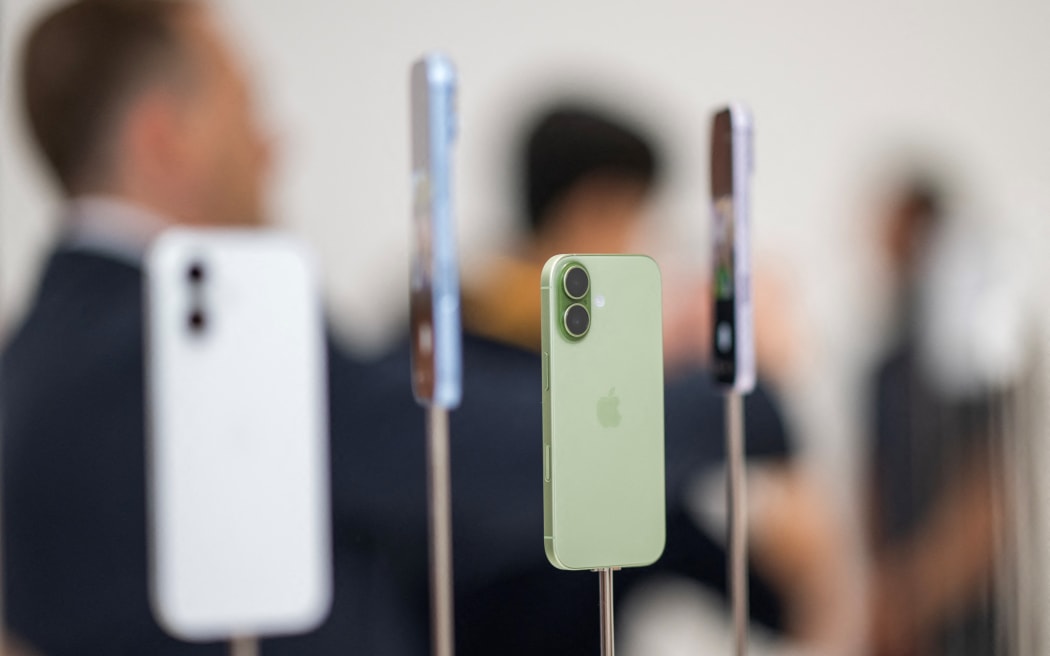 Apple iPhone 17 models are displayed during Apple's "Awe-Dropping" event at the Steve Jobs Theater on the Apple Park campus in Cupertino, California, on September 9, 2025. (Photo by Nic Coury / AFP)