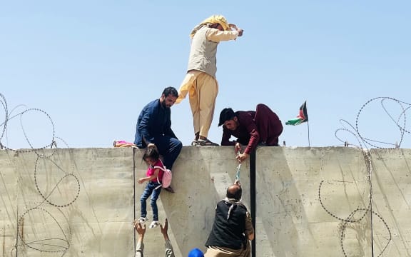 KABUL, AFGHANISTAN-AUGUST 16: Thousands of Afghans rush to the Hamid Karzai International Airport as they try to flee the Afghan capital of Kabul, Afghanistan, on August 16, 2021.