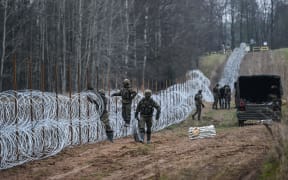 Polish soldiers construct a barrier on Poland's border with the Russian exclave Kaliningrad on 5 November, 2022.
