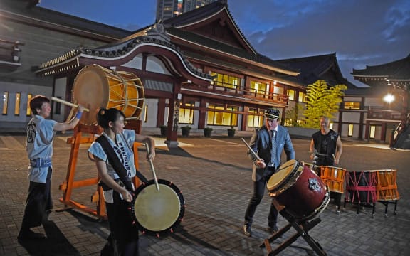 All Black Brad Webber plays drums after a welcome ceremony at Zojoji temple in Tokyo on September 14, 2019.