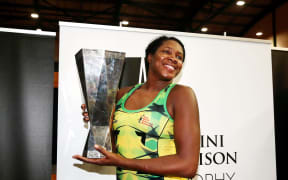 Jhaniele Fowler Reid of Jamaica celebrates with the Taini Jamison Trophy after winning the final against the Silver Ferns.
