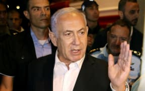 Israeli Prime Minister Benjamin Netanyahu tours the city of Lod early on May 12, 2021.