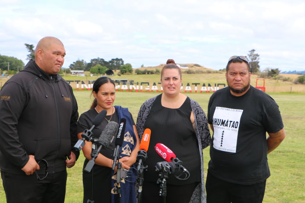Pania Newton, Qiane Matata-Sipu and other members of SOUL after the Kiingitanga flag was lowered at Ihumātao.