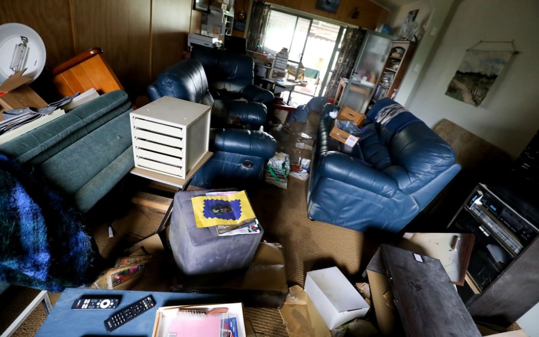 Colin Payne said he's devastated to see 85 years worth of collections and family heirlooms drenched by floodwaters.