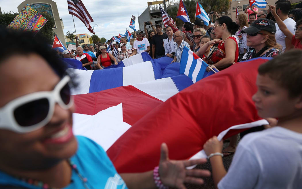People take to the streets outside the restaurant Versailles in Miami, Florida, as they react to the news of the death of former Cuban President Fidel Castro.