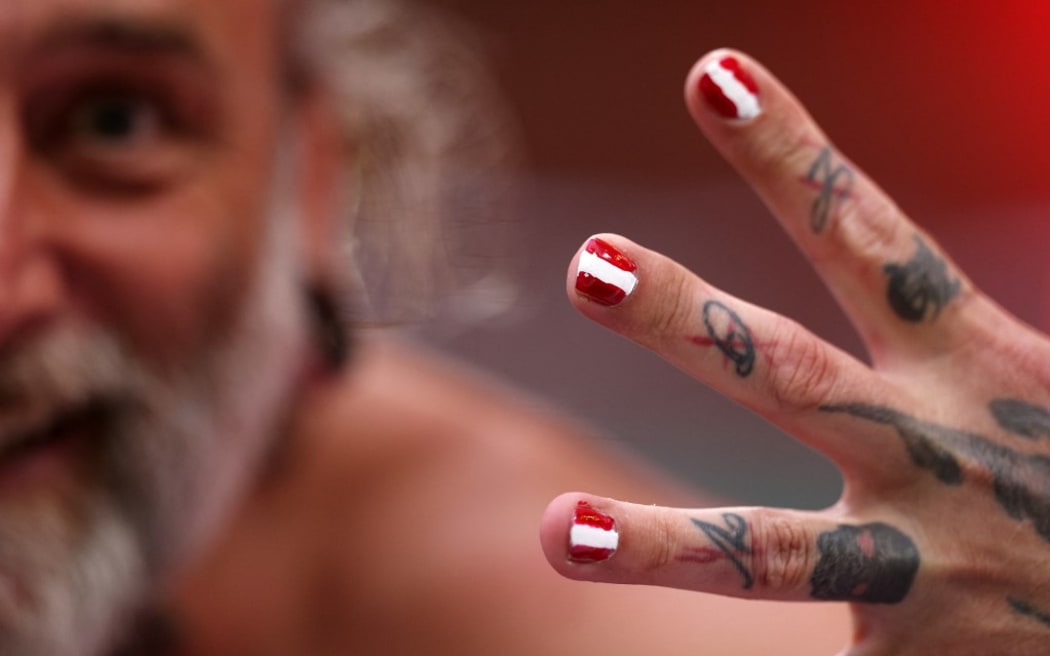 A supporter shows his nails in the colours of the Austrian flag before the UEFA Euro 2024 round of 16 football match between Austria and Turkey at the Leipzig Stadium in Leipzig on July 2, 2024. (Photo by Adrian DENNIS / AFP)