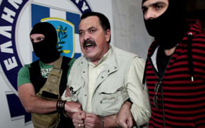 Christos Pappas of the extreme far-right Golden Dawn party, is escorted by police to the prosecutor's office on September 29, 2013