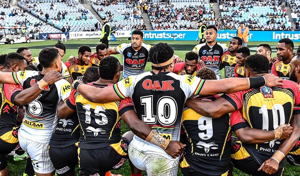 PNG Hunters and Penrith Panthers players huddle together following the NRL State Championship match.
