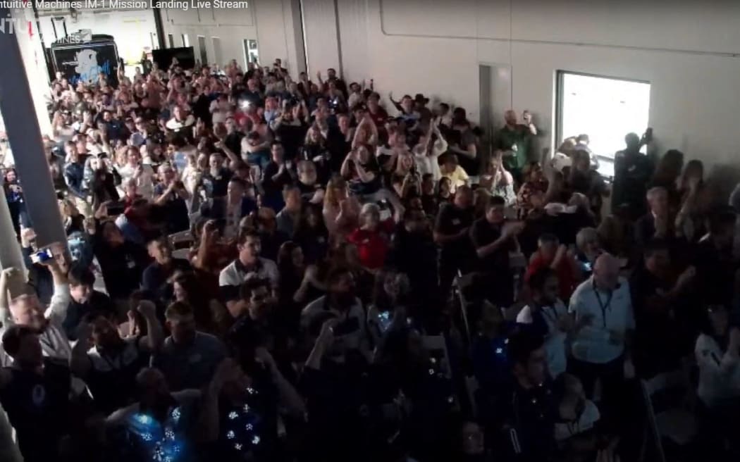 This frame grab from Nasa, shows Scorpius Space Launch Company (SSLC) employees and guests reacting as the Intuitive Machines' Odysseus lunar lander touches down on the moon, in Torrance, California, on February 22, 2024. A commercial US spaceship has landed on the surface of the Moon and flight controllers have received a signal from the vessel, the company behind the mission said Thursday.
