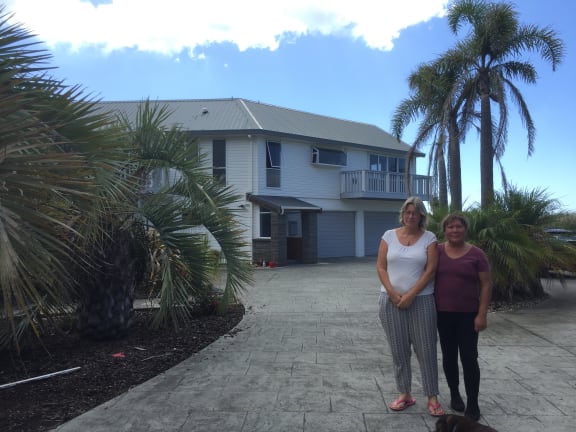 Former neighbours Rachel Whalley and Tawai Thatcher in front of the Whalley's family home on Clem Elliot Drive