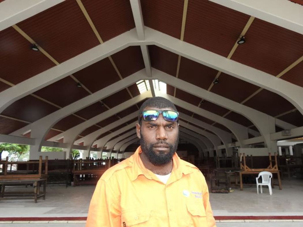 Manager of the Port Vila Central Market Daniel Poussai in front of newly painted market building.