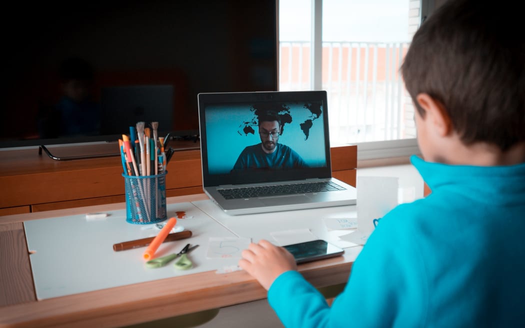 Kid studying homework math during his online lesson at home, social distance during quarantine. Self-isolation and online education concept caused by coronavirus pandemia