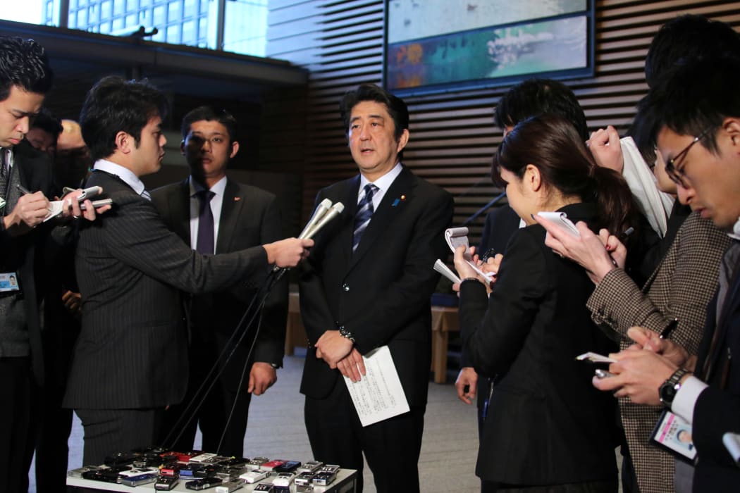 Shinzo Abe speaking to reporters at his official residence.