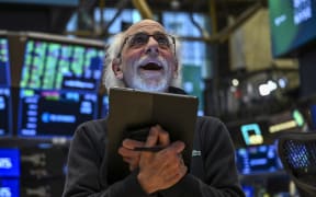 A trader works on the floor of the New York Stock Exchange (NYSE) during afternoon trading on April 9, 2025 in New York. Wall Street stocks rocketed to close solidly higher Wednesday, with dramatic advances on all three major indexes as US President Donald Trump delayed steep new tariffs hours after they took effect. The Dow Jones Industrial Average surged 7.9 percent to 40,608.45, the broad-based S&P 500 Index rallied 9.5 percent to 5,456.90, and the tech-focused Nasdaq Composite Index jumped more than 12.2 percent to 17,124.97. (Photo by ANGELA WEISS / AFP)