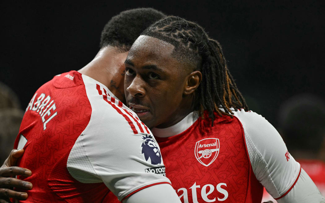 Arsenal's English midfielder Eberechi Eze (R) embraces teammate Arsenal's Brazilian defender Gabriel Magalhaes.
