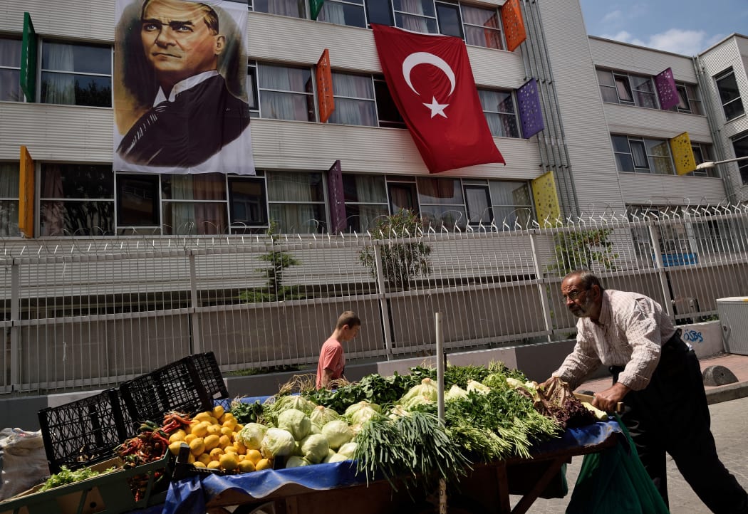 A street seller pushes his cart with fruits and vegetables next to a religious school in the Kasimpasa neighborhood in Istanbul where Turkish President Recep Tayyip Erdogan was born.