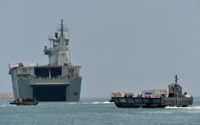 The Royal Australian Navy ship HMAS Canberra (L02) (C) and landing craft (R) take part in training excercise in the Sri Lankan capital Colombo on March 26, 2019.