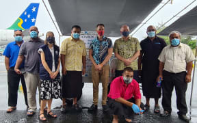 Kiribati Covid-19 vaccines arrive 25 May 2021 (L to R) MPs Koraubati Remuera & Betero Ataninora, Dr Wendy Snowden (WHO), Dr Tinte Itinteang (MHMS), David Yardley (Australian HC), Paul Wallis (NZ HC), MP Ioteba Redfern (squatting), Waqairapoa Tikoisuva (UNICEF) & MP Batoromaio Kiritian.