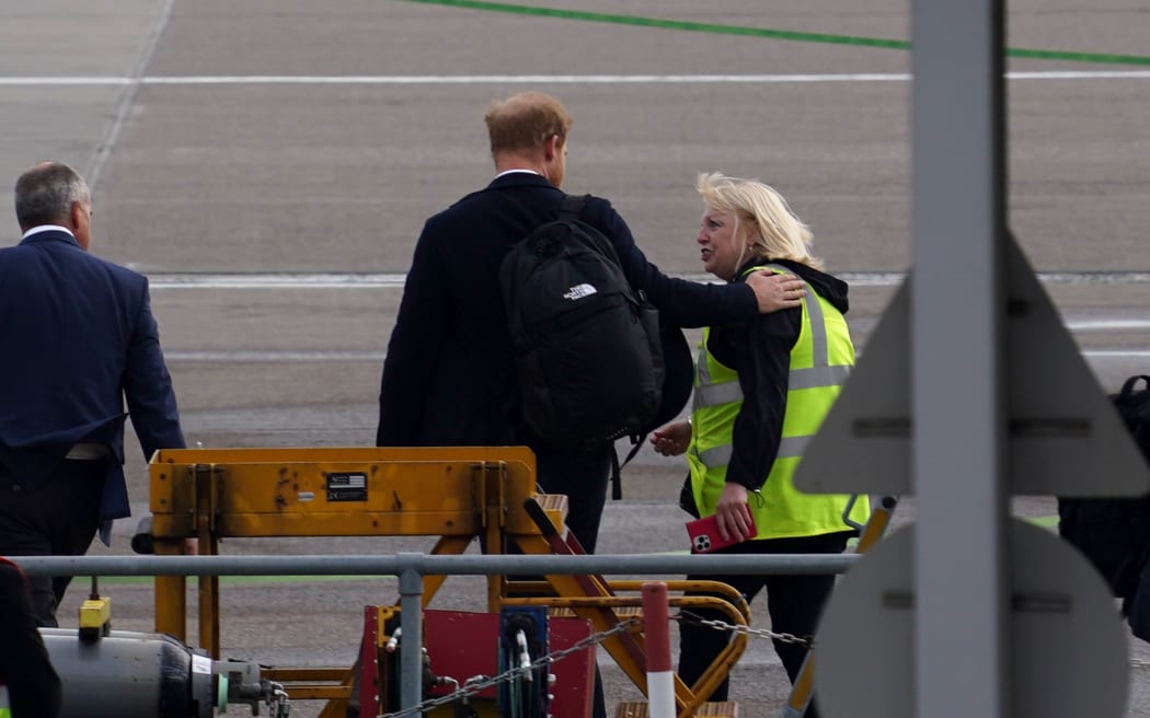 Prince Harry, Duke of Sussex boards a flight at Aberdeen Airport in Aberdeen, United Kingdom, a day after the death of his grandmother, Queen Elizabeth II.