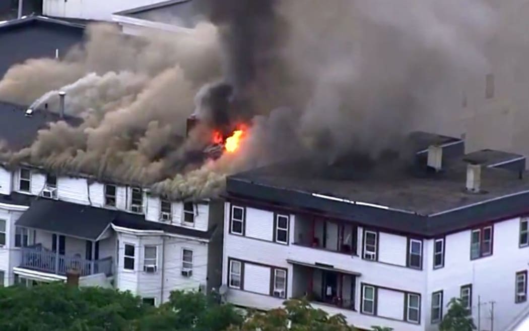 A screenshot from local media shows one of the buildings that caught fire after a series of explosions.