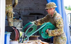 ADF personnel unload a truck containing HESCO fortification barriers during Operation RENDER SAFE, Nauru.