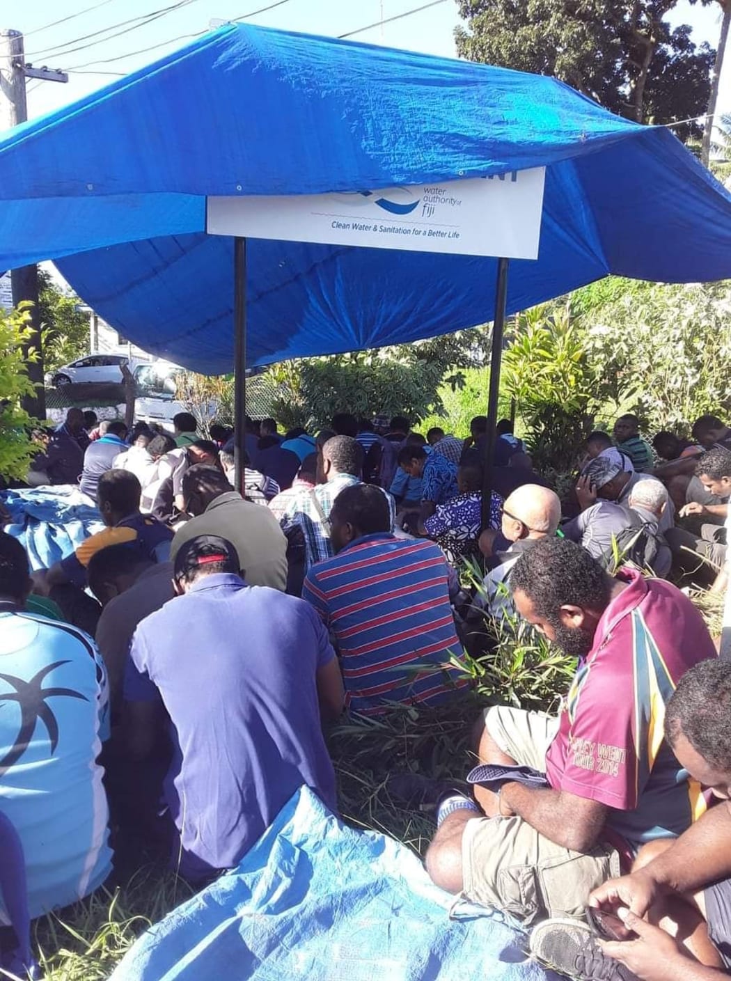 Water Authority of Fiji workers wait outside the company's Kinoya station in the capital this morning.