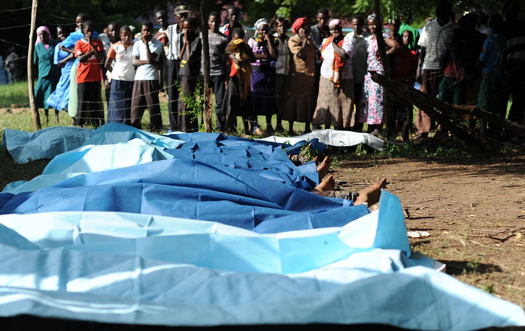 Family members wait to collect bodies of their relatives at Mpeketoni hospital in Lamu county, after at least 48 heavily-armed gunmen attacked the town.
