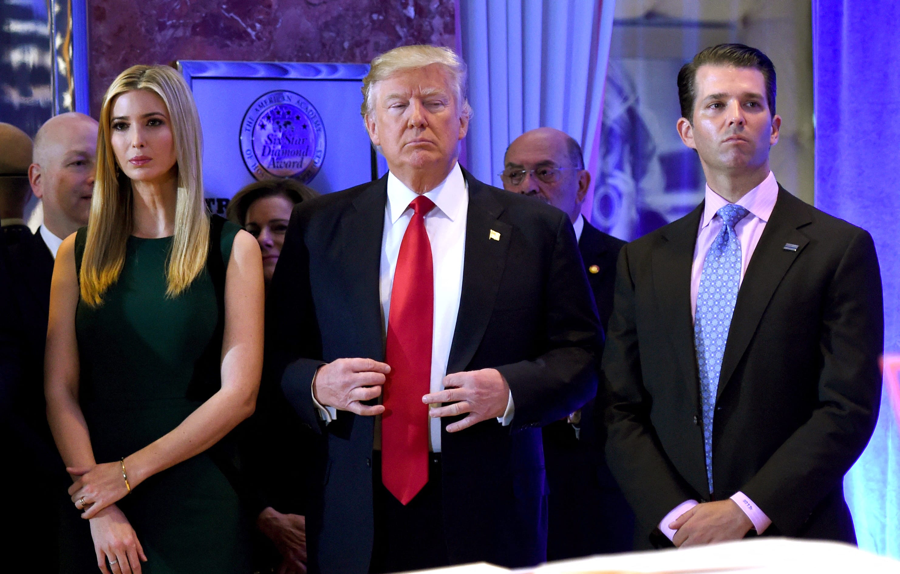 In this file photo taken on January 11, 2017 US President-elect Donald Trump stands with his children Ivanka and Donald Jr., during Trump's press conference at Trump Tower in New York.
