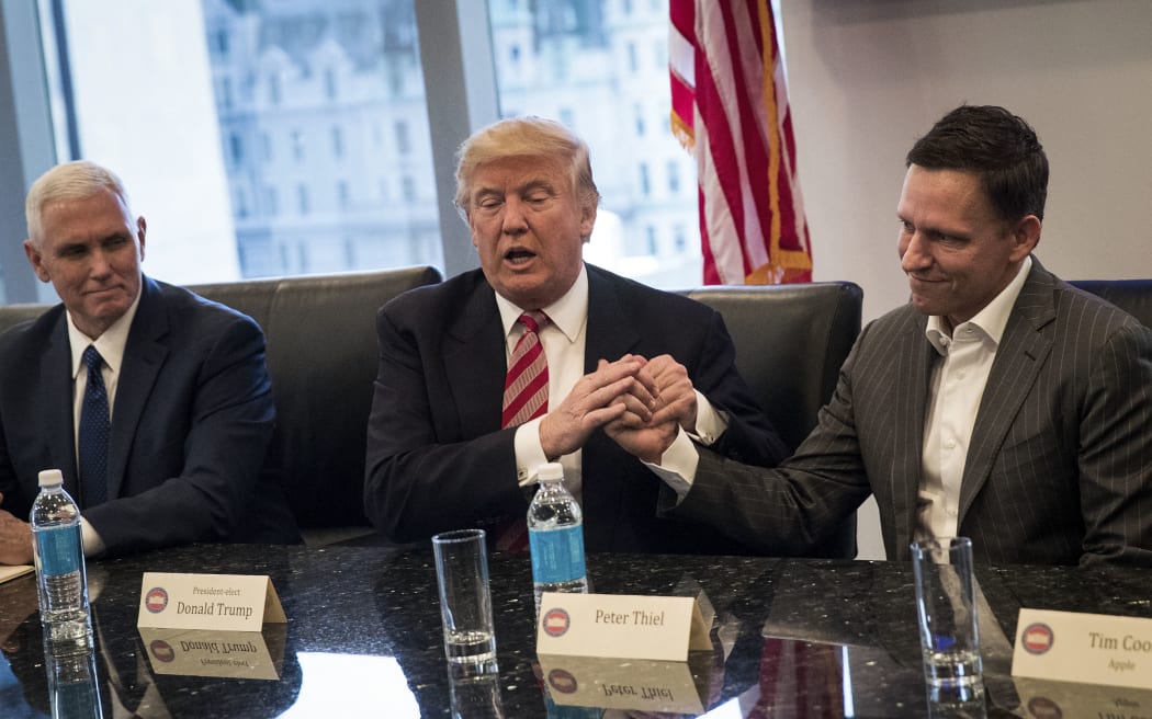 NEW YORK, NY - DECEMBER 14: (L to R) Vice President-elect Mike Pence looks on as President-elect Donald Trump shakes the hand of Peter Thiel during a meeting with technology executives at Trump Tower, December 14, 2016 in New York City. This is the first major meeting between President-elect Trump and technology industry leaders.   Drew Angerer/Getty Images/AFP (Photo by Drew Angerer / GETTY IMAGES NORTH AMERICA / Getty Images via AFP)