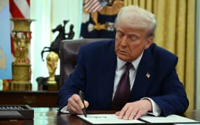 US President Donald Trump signs an Executive Order on reciprocal tariffs in the Oval Office of the White House in Washington, DC, on February 13, 2025. Trump announced that he would impose "reciprocal tariffs" on trading partners, opening new fronts in his trade war. The move would match US tariff rates on imports to the levels that other countries impose on US goods. (Photo by ANDREW CABALLERO-REYNOLDS / AFP)