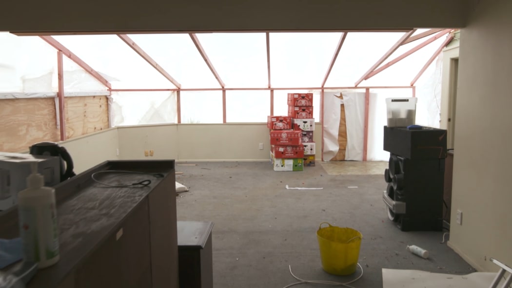 Inside a tornado-hit, shrink-wrapped home in Papatoetoe.