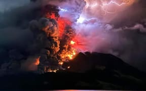 A photograph taken and released by the Center for Volcanology and Geological Hazard Mitigation on 17 April, 2024, shows Mount Ruang spewing hot lava and smoke as seen from Sitaro, North Sulawesi in Indonesia.