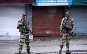 Security personnel stand guard on a street in Jammu.