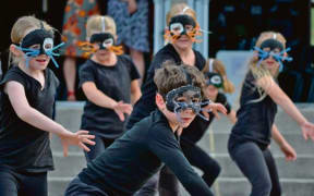Members of the Ohope Beach School Choir performing the Evil Weasel Gang dance