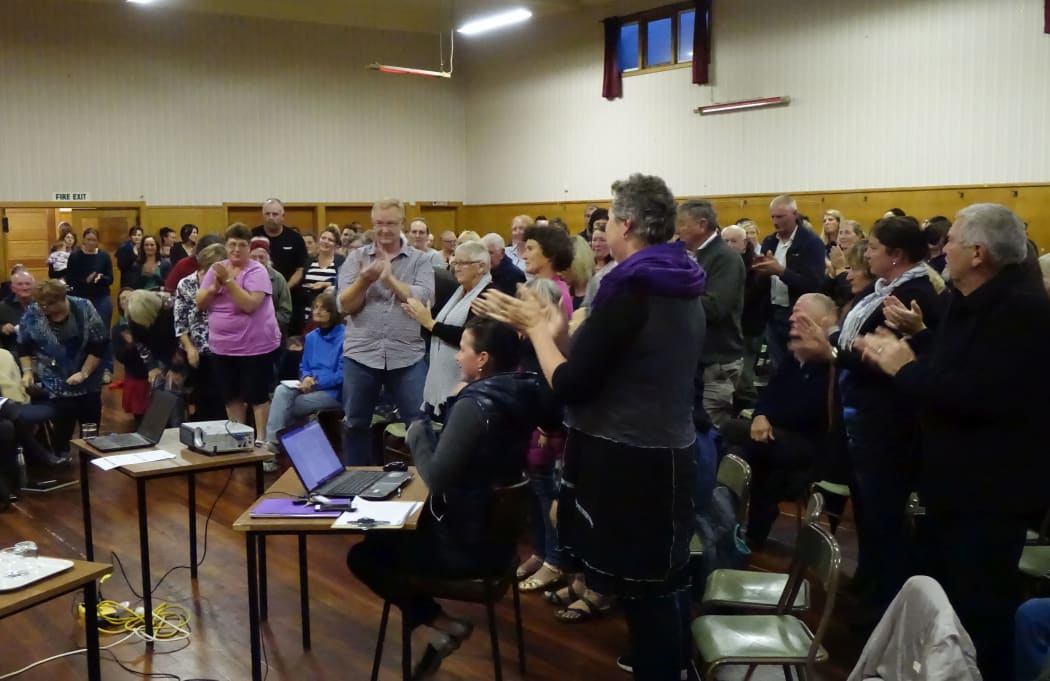 A speaker receives a standing ovation.