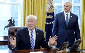 WASHINGTON, DC - MARCH 24: U.S. President Donald Trump reacts with Vice President Mike Pence (R) after Republicans abruptly pulled their health care bill from the House floor, in the Oval Office of the White House on March 24, 2017 in Washington, DC.
